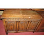 An early 20th century relief carved and joined oak three panelled hinged top coffer, in the 17th