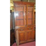 A Victorian mahogany bookcase cupboard, having twin glazed upper doors, w.107cm