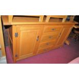 A contemporary light elm planked top sideboard, having cleated ends, and four central drawers