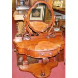 A mid-Victorian mahogany duchess dressing table, having swing mirrorback and lower platform, w.