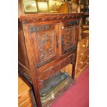 A 17th century style relief carved oak double door side cupboard having exposed iron hinges, width