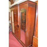 A circa 1900 mahogany, flame mahogany and chequer strung triple wardrobe (lacking one mirrorplate to