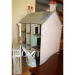 A large early 20th century childs' three-storey double-sided dolls house, painted in various