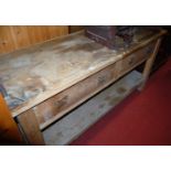 A Victorian pine dresser base having twin frieze drawers over pot board undertier, width 183cm