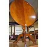 A Georgian style mahogany tilt-top circular pedestal tripod table, dia. 68cm