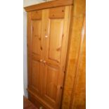 A modern pine double door wardrobe, with single long lower drawer