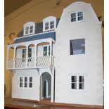 A three-storey dolls house in the Edwardian taste, together with sundry dolls house furniture and
