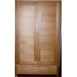 A good contemporary light oak double door wardrobe, having single long lower drawer, w.115cm