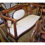 An Edwardian mahogany, satinwood strung and further cream floral upholstered two-seater salon sofa