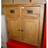A contemporary light oak small double door side cupboard having twin upper drawers, width 75cm
