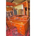 An Edwardian mahogany swing mirror back kneehole dressing table, w.110cm