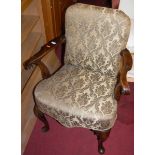 An early 20th century walnut framed and floral upholstered open armchair in the Georgian taste