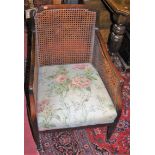 A pair of early 20th century mahogany and cane inset bergère chairs