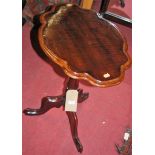 A 19th century mahogany shaped top fixed pedestal tripod occasional table