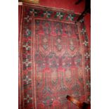 A Persian woollen rug, having an architectural field and trailing tramline borders, 248 x 120cm (