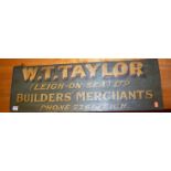 An early 20th century painted oak double-sided shop sign for W.T. Taylor Builders Merchants