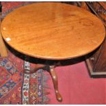 A George III mahogany circular pedestal tilt-top tripod table, raised on hipped supports, dia. 79cm