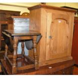 A rustic pine single door wall cupboard, together with a moulded oak drop flap occasional table (2)