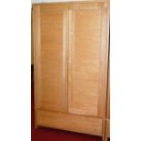 A good contemporary light oak double door wardrobe, having single long lower drawer, w.115cm
