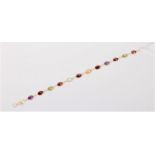 A 14ct m ulti gem set bracelet, comprised of oval amethyst, garnet, peridot, topaz and citrine,