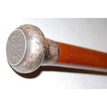 A mallacca walking cane, the silver top inset with a 19th century Thai baht coin