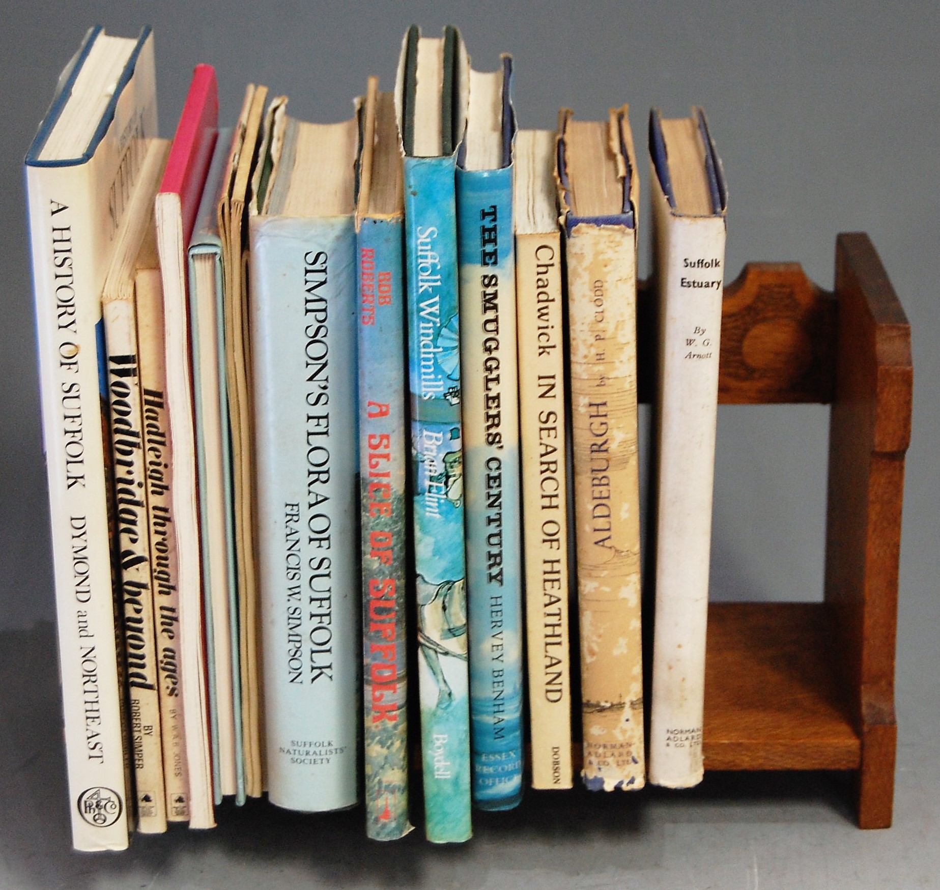 An early 20th century oak book trough, having pokerwork decoration; together with a small collection