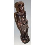 An African carved ebony fertility figure in the form of a nursing woman, h.45cm