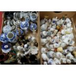 Two boxes containing a quantity of collectable china and figurines, to include ceramic bells, blue