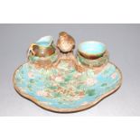 A Victorian majolica strawberry dish, on a turquoise ground with applied floral decoration,