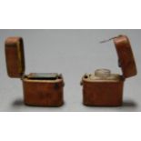 An early 20th century smelling salts bottle in fitted leather case, together with a similar vesta (