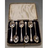 A cased set of six silver teaspoons, each with golf club embossed terminals