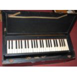 A mid-20th century leather cased American travel organ, from the Astey Organ Corporation of the USA,