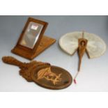 An early 20th century olive wood souvenir folding mirror together with an olive wood fan and hand