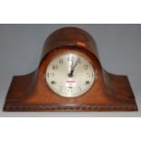 A 1930s oak cased mantel clock, having silvered dial with Arabic numerals and eight day movement