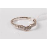 An 18ct white gold diamond ring, the shaped half hoop diamond ring, stamped '750', London, size