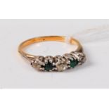 An 18ct five stone emerald and diamond ring, the alternating cushion cut emeralds and old round