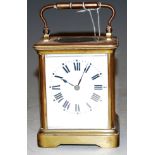 An early 20th century lacquered brass cased carriage clock having enamelled dial with Roman numerals