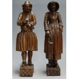 A pair of late 19th century Continental carved oak figures of a man and woman, h.34cm