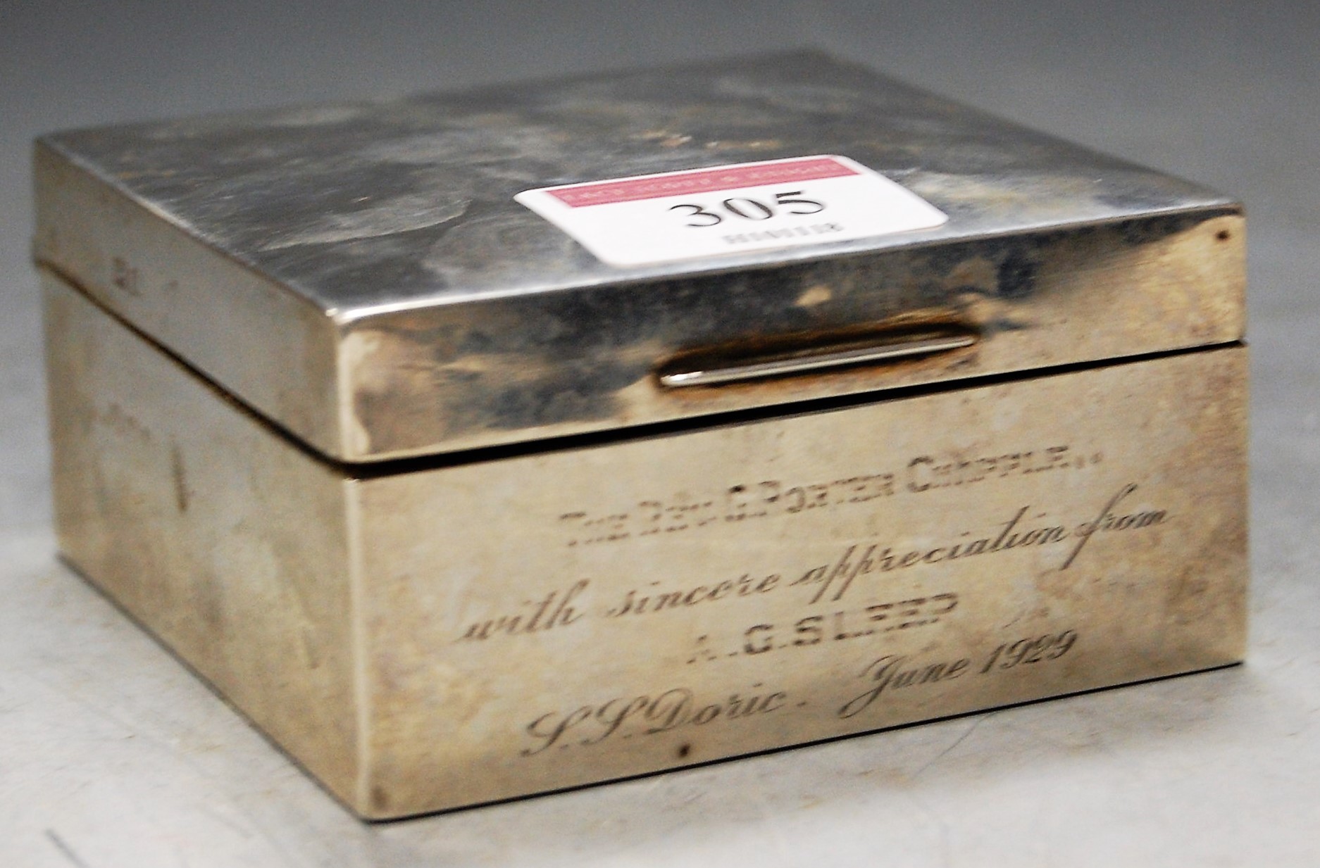 A silver table cigarette box, with presentation inscription , w.8.5cm