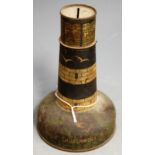 An early 20th century lithograph printed novelty moneybox in the form of a lighthhouse, printed