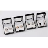A pair of blue topaz earrings, a pair of sapphire and CZ earrings, and two pairs of CZ set earrings,