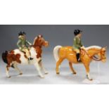 A pair of Beswick figures, a skewbald pony with girl rider and a Palomino horse with boy rider (2)