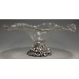 A large Murano clear glass table centrepiece of wavy form, raised on a silvered metal naturalistic
