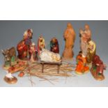 A collection of carved softwood and polychrome painted nativity figures
