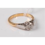 An 18ct diamond ring, the illusion set diamond with tapered shoulders of white gold, set to a