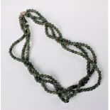 A three strand nephrite bead necklace, with white metal and faux pearl clasp, 48cm long