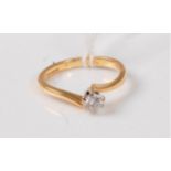 An 18ct diamond solitaire crossover ring, the round brilliant cut diamond estimated approx. 0.20cts,
