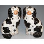 A pair of Victorian Staffordshire figures of seated spaniels, h.27cm