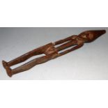 A Sepik carved ancestor figure of a man, with long stylised face and slender body, height 50cm