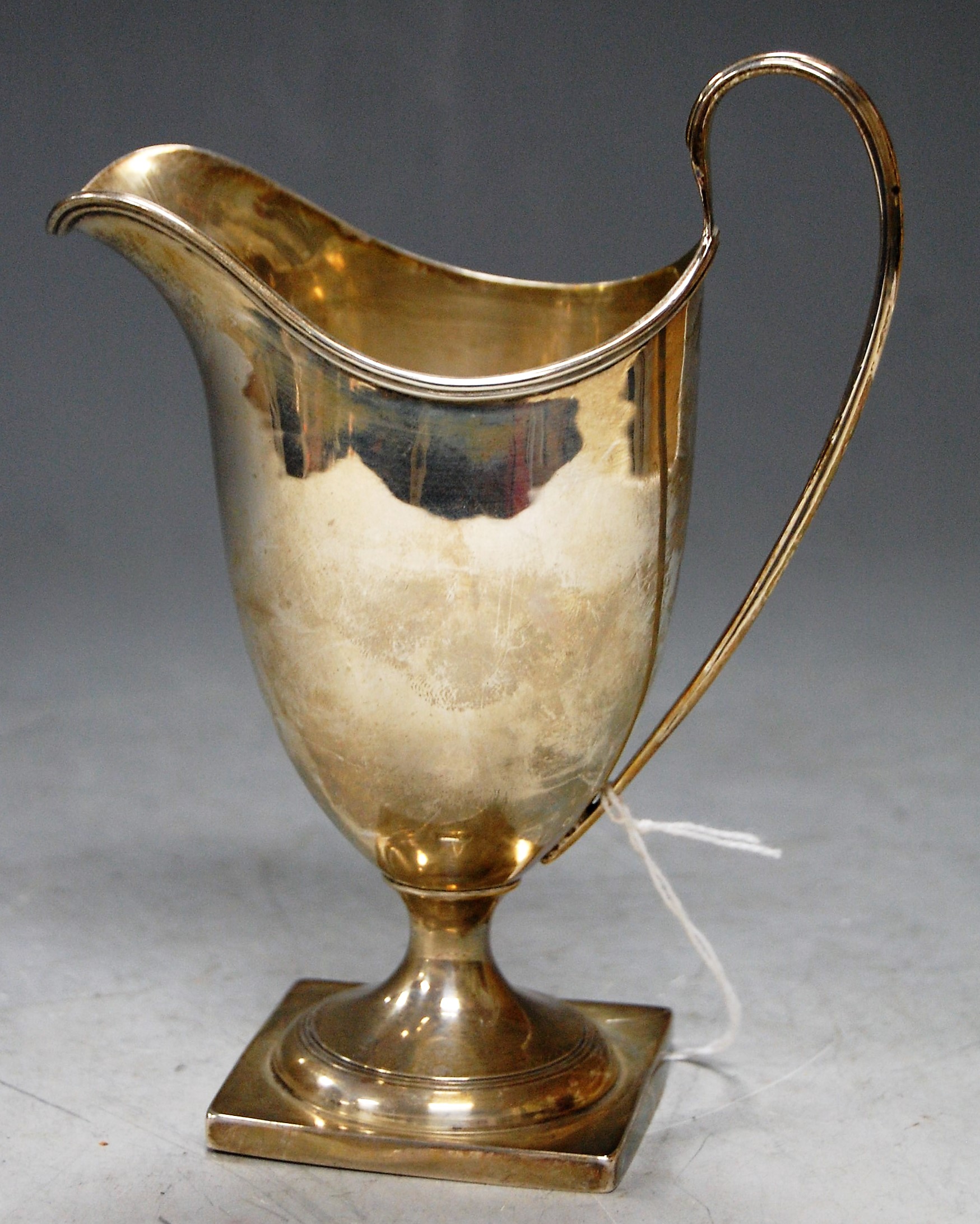 An Edwardian silver pedestal helmet form cream jug, 4.4oz, h.15cm